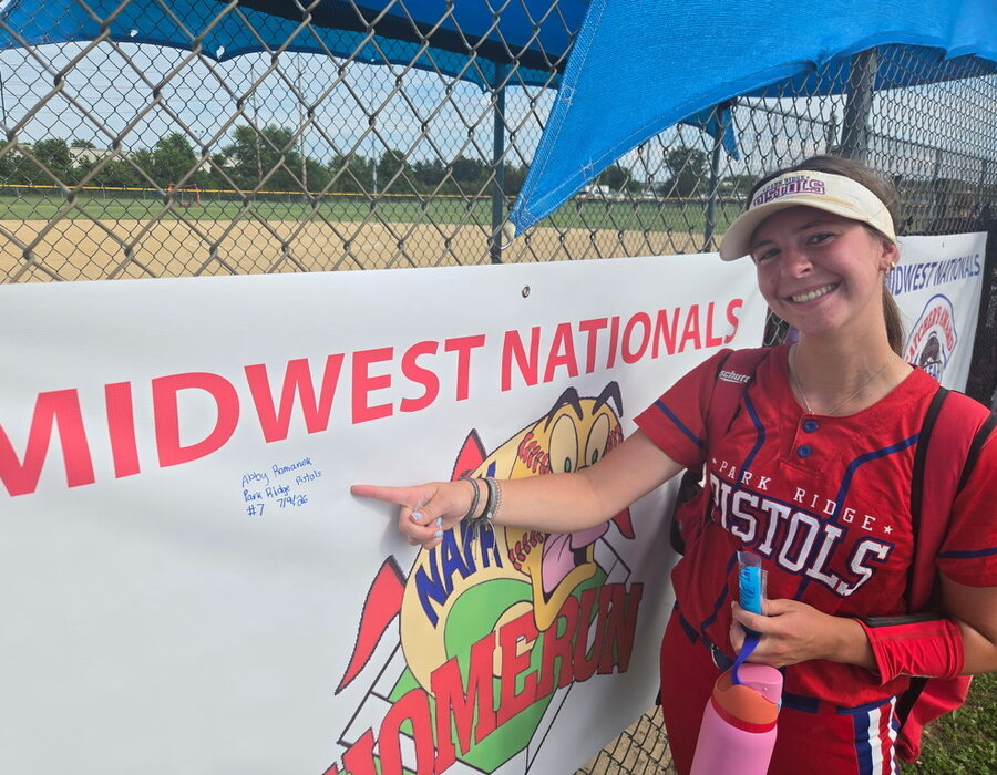 A Pistols player beside the home run banner at the NAFA Midwest Nationals